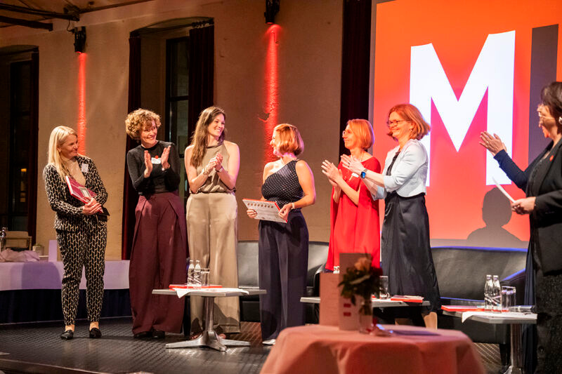 Dr. Nea Krivokapa-Williams on stage with a panel of women leaders