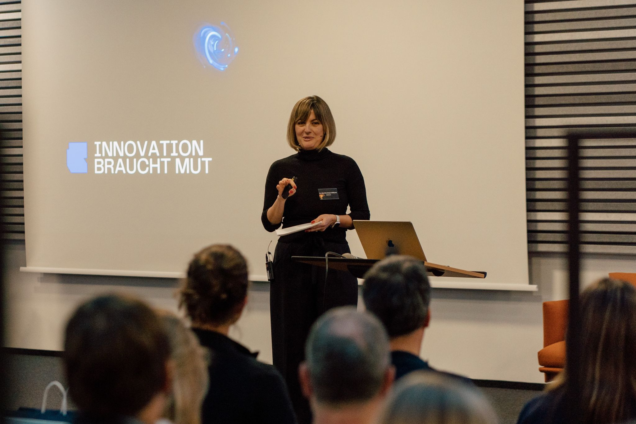 Dr. Nea Krivokapa-Williams speaking about innovation to a live audience